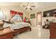 Spacious bedroom with a large bed, ceiling fan, and plenty of natural light at 24018 W Wayland Dr, Buckeye, AZ 85326