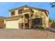 Two-story house with a large driveway and desert landscaping at 24018 W Wayland Dr, Buckeye, AZ 85326