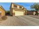 Two-story house with a large driveway and desert landscaping at 24018 W Wayland Dr, Buckeye, AZ 85326