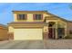Two-story house with a large driveway and desert landscaping at 24018 W Wayland Dr, Buckeye, AZ 85326