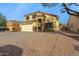 Two-story house with a large driveway and desert landscaping at 24018 W Wayland Dr, Buckeye, AZ 85326
