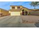 Two-story house with a large driveway and desert landscaping at 24018 W Wayland Dr, Buckeye, AZ 85326