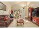 Spacious living room with brown leather furniture and a Christmas tree at 24018 W Wayland Dr, Buckeye, AZ 85326