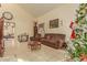 Spacious living room with brown leather furniture and a Christmas tree at 24018 W Wayland Dr, Buckeye, AZ 85326