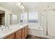 Bathroom with double vanity, soaking tub, and shower at 29007 N 120Th Dr, Peoria, AZ 85383