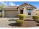 House exterior with stone accents and two-car garage at 29007 N 120Th Dr, Peoria, AZ 85383