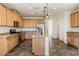 Modern kitchen with light wood cabinets and granite countertops at 29007 N 120Th Dr, Peoria, AZ 85383