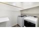 Laundry room with washer, dryer, and ample shelving at 29007 N 120Th Dr, Peoria, AZ 85383