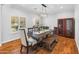 Elegant dining room featuring a large table, hardwood floors, and natural light at 3617 E Hazelwood St, Phoenix, AZ 85018