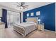 Main bedroom with plush bed, blue accent wall, and plenty of natural light at 3914 E Carson Rd, Phoenix, AZ 85042