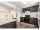 Modern kitchen with dark wood cabinets and quartz countertops at 3921 W Griswold Rd, Phoenix, AZ 85051