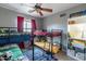 Bedroom with bunk beds, built-in shelving, and ceiling fan at 4541 W Federal Way, San Tan Valley, AZ 85144