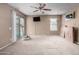 Carpeted bedroom with sliding door to patio and pool view at 4543 N 101St Ave, Phoenix, AZ 85037