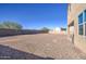 Large backyard with gravel and block wall at 4689 E Argentite St, San Tan Valley, AZ 85143