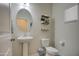 Clean bathroom with pedestal sink and oval mirror at 4689 E Argentite St, San Tan Valley, AZ 85143