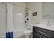 Clean bathroom with tub shower, dark vanity, and white toilet at 4689 E Argentite St, San Tan Valley, AZ 85143