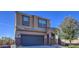 Two-story house with a large dark gray garage door and landscaping at 4689 E Argentite St, San Tan Valley, AZ 85143