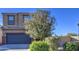 Two-story house with a dark gray garage door and tree at 4689 E Argentite St, San Tan Valley, AZ 85143