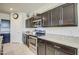 Modern kitchen with dark brown cabinets and granite countertops at 4689 E Argentite St, San Tan Valley, AZ 85143
