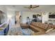 Spacious living room with brown sectional sofa and large TV at 4689 E Argentite St, San Tan Valley, AZ 85143