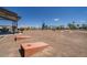 Community recreational area with cornhole and covered seating at 5248 N 176Th Ln, Litchfield Park, AZ 85340