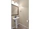 Small bathroom with pedestal sink, mirror, and tiled floor at 66 W Hayden Park Rd, San Tan Valley, AZ 85143