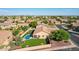 Aerial view of house with pool and backyard, showcasing surrounding neighborhood at 6898 W Saint John Rd, Glendale, AZ 85308