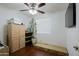 Bedroom with wood floors, built-in shelving, and ceiling fan at 8214 S 26Th St, Phoenix, AZ 85042