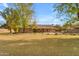 Large grassy backyard with mature trees, offering ample space for outdoor activities at 942 N Miramar --, Mesa, AZ 85213