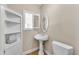 Convenient half bathroom with pedestal sink and shelving at 942 N Miramar --, Mesa, AZ 85213