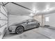 Garage with Tesla and built-in storage at 942 N Miramar --, Mesa, AZ 85213