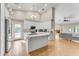 Modern kitchen with white cabinets, center island, and stainless steel appliances at 942 N Miramar --, Mesa, AZ 85213