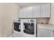 Laundry room with washer, dryer and upper cabinets at 942 N Miramar --, Mesa, AZ 85213