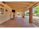Covered patio features brick flooring, outdoor seating, and access to the backyard pool at 942 N Miramar --, Mesa, AZ 85213
