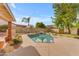 Inviting kidney-shaped pool with a waterfall feature, surrounded by a well-landscaped yard at 942 N Miramar --, Mesa, AZ 85213