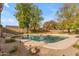Relaxing kidney shaped pool with a rock waterfall feature in a large backyard at 942 N Miramar --, Mesa, AZ 85213