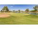 Green grass and a lake in a golf course at 10214 E Michigan Ave, Sun Lakes, AZ 85248
