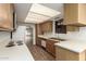 Bright kitchen with white countertops and wood cabinets at 10214 E Michigan Ave, Sun Lakes, AZ 85248