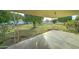 Large backyard with grassy area and mature trees at 10225 N 105Th Dr, Sun City, AZ 85351