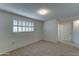 Bright bedroom with window shutters and neutral carpeting at 10225 N 105Th Dr, Sun City, AZ 85351