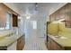 Retro kitchen with wood cabinets and tiled floor at 10225 N 105Th Dr, Sun City, AZ 85351