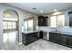 Modern kitchen with dark cabinetry, granite counters at 1089 S Annie Ln, Gilbert, AZ 85296