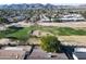 Aerial view of home on golf course with mountain backdrop at 11642 S Half Moon Dr, Phoenix, AZ 85044