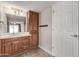 Bathroom with wood vanity, mirror and additional storage at 12414 W Cougar Dr, Sun City West, AZ 85375