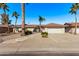 Single-story home with a two-car garage and landscaped front yard at 12414 W Cougar Dr, Sun City West, AZ 85375