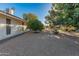 Backyard view showing gravel, trees, and home exterior at 12903 W Copperstone Dr, Sun City West, AZ 85375