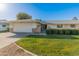 House exterior featuring a two-car garage and well-manicured lawn at 12903 W Copperstone Dr, Sun City West, AZ 85375