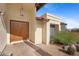 Front entrance with double wood doors and desert landscaping at 16010 E El Lago Blvd, Fountain Hills, AZ 85268