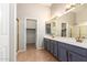 Double vanity bathroom with a shower and linen closet at 19522 N 84Th Ave, Peoria, AZ 85382