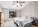 Spacious bedroom with a king-size bed and ceiling fan at 19522 N 84Th Ave, Peoria, AZ 85382